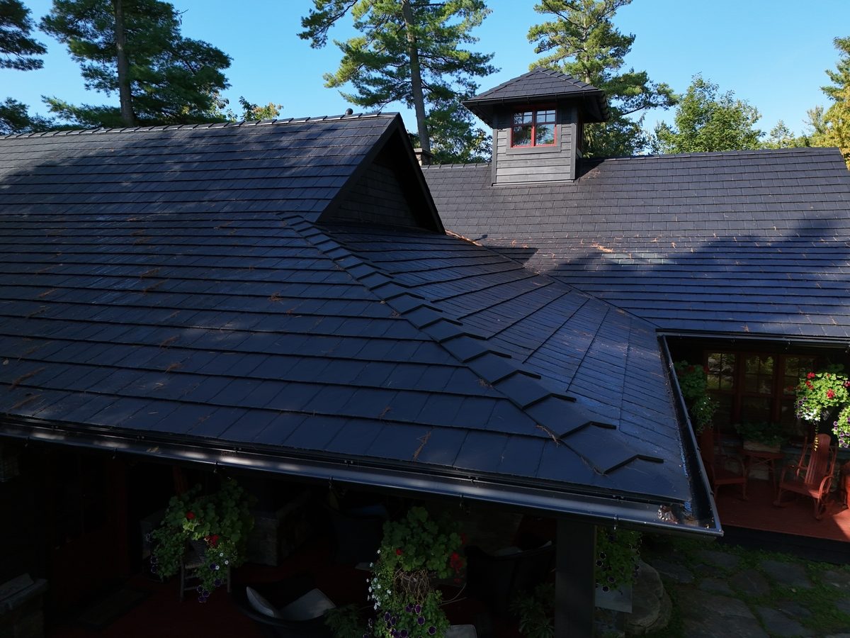 Black eavestrough along a shingle roof